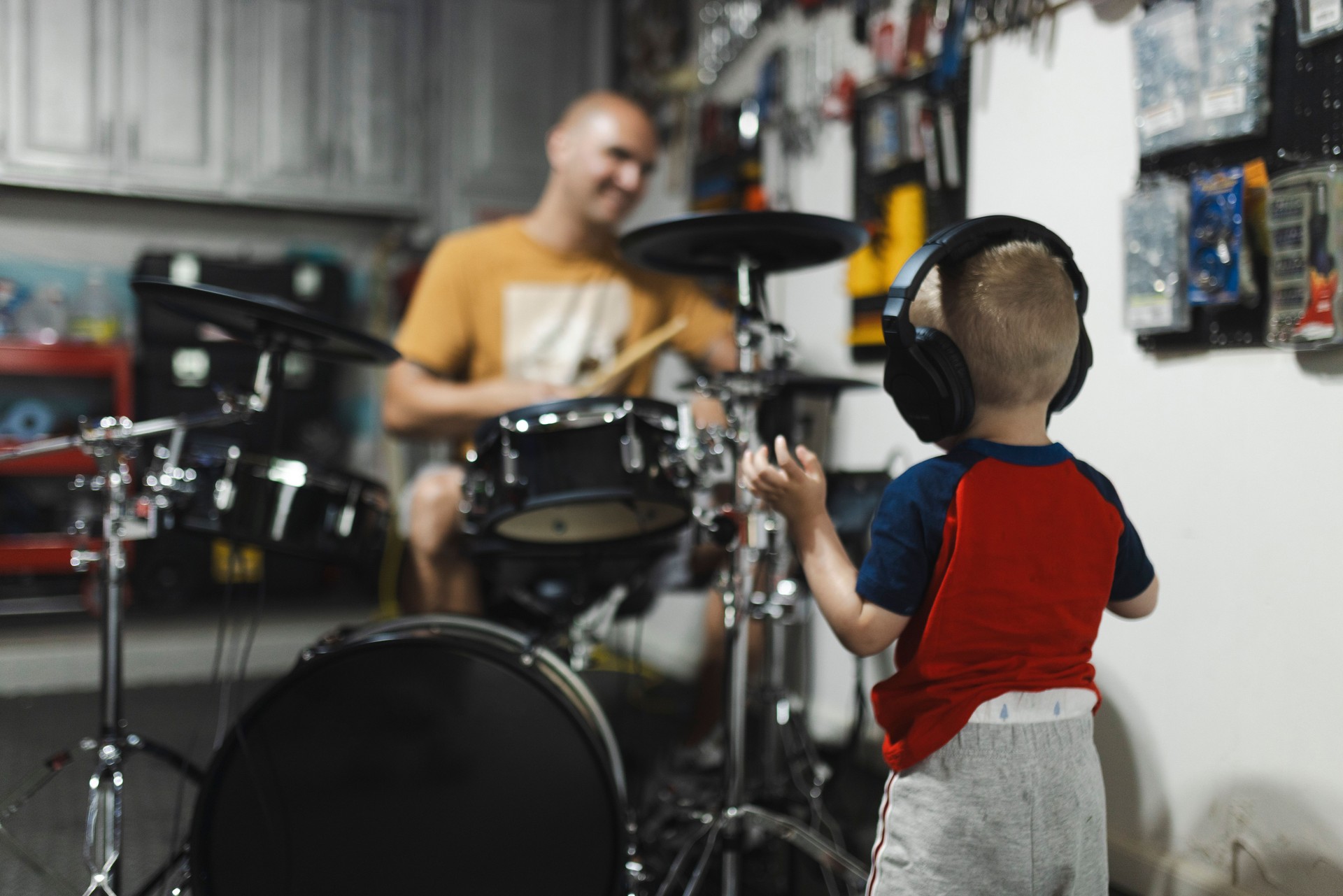 A father teaching his son to play the drums