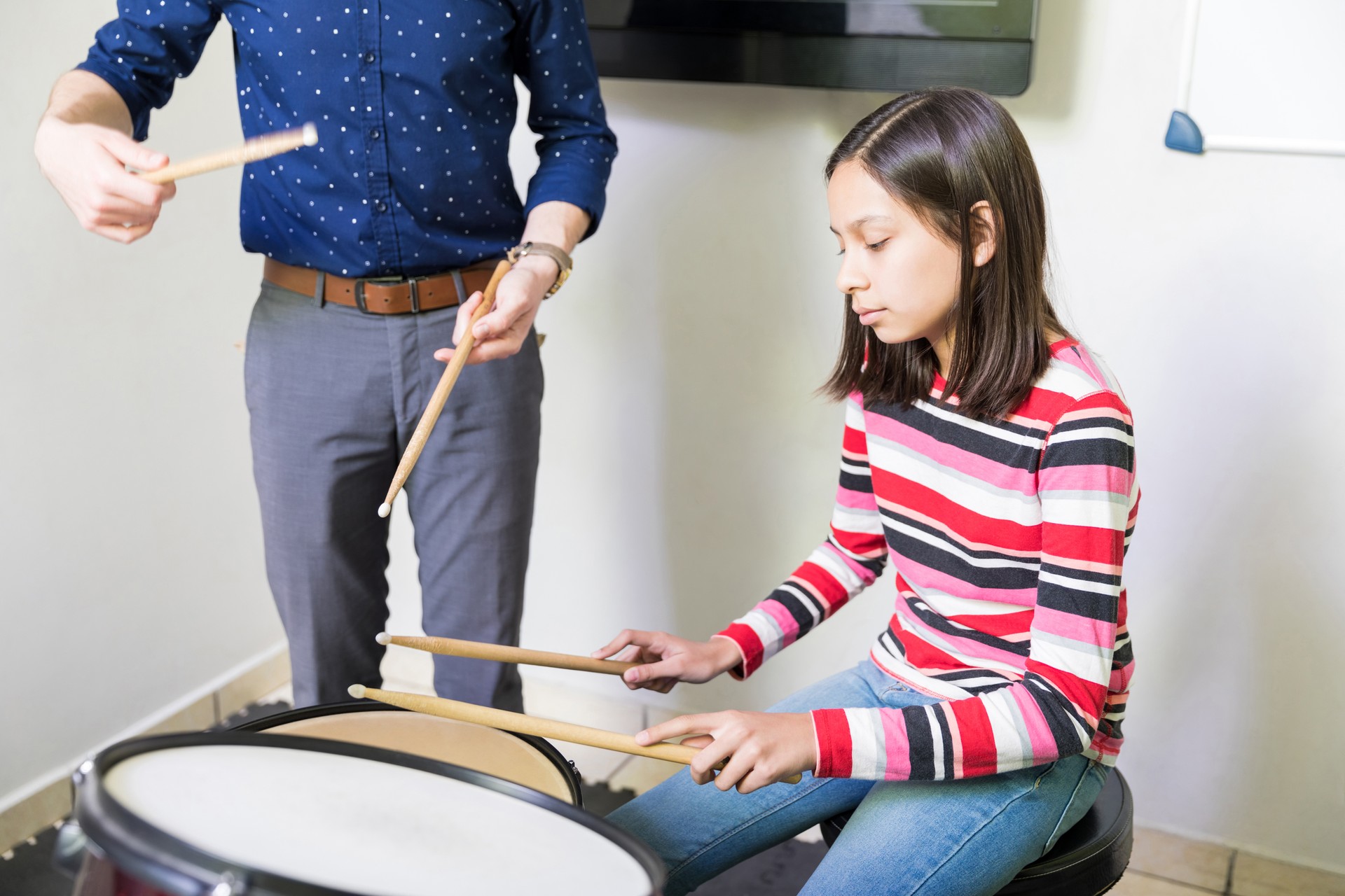 Kid With Teacher Practicing Drum In Music Class